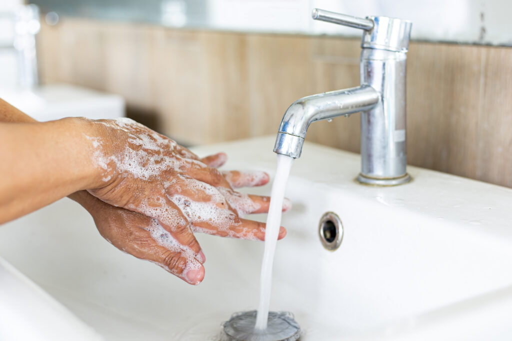 RLT | Novartis - Klinische Forschung - Person wäscht sich Hände mit Seife unter laufendem Wasser RLT | Novartis - Klinische Forschung - Person wäscht sich Hände mit Seife unter laufendem Wasser